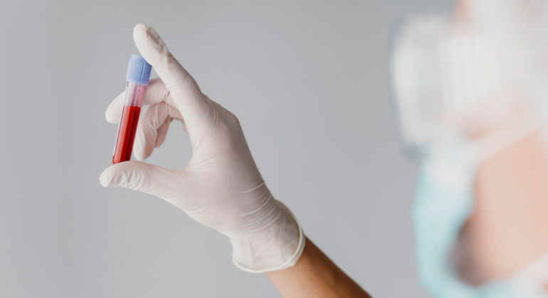 doctor holding test tube filled with blood