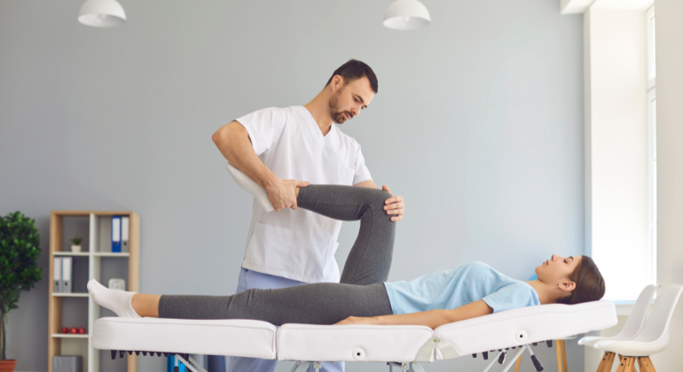 Physiotherapist performing knee rehabilitation exercises on a patient for pain relief and mobility improvement