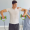 Physiotherapist guiding a male athlete through shoulder rehabilitation exercises using resistance bands during a sports injury recovery session.
