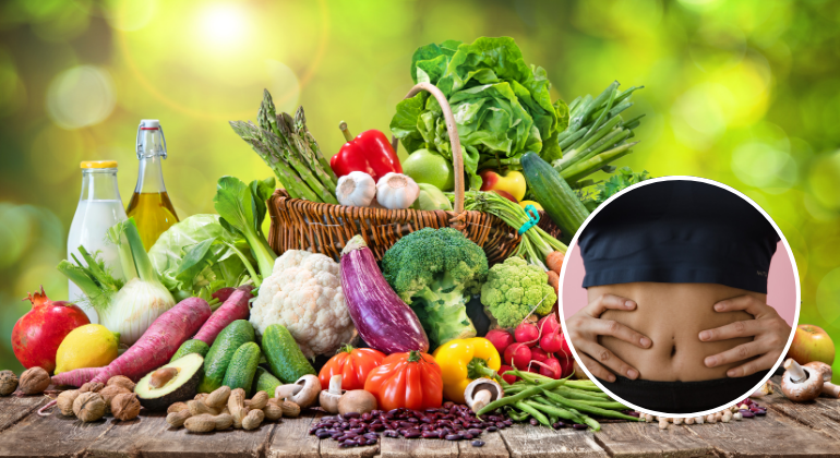 A colorful assortment of fresh vegetables, fruits, and healthy foods on a wooden table, symbolizing a nutritious diet for recovery. Inset shows a person holding their abdomen, indicating the importance of diet in supporting navel displacement recovery.